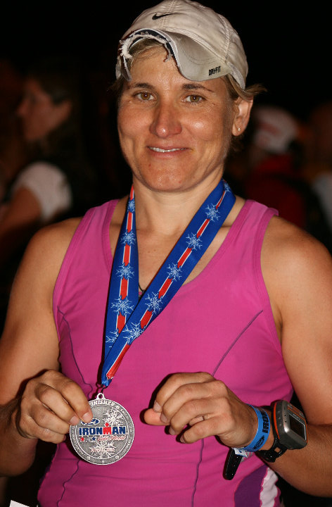 Kelly Barnes with her Ironman finisher medal